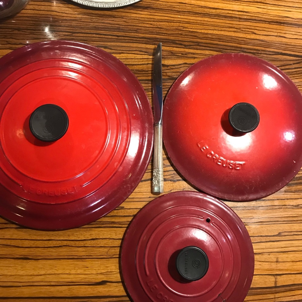 Le Creuset enamel pot lids. Prices vary
